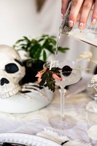 mixing up a Mezcal martini halloween cocktail recipe