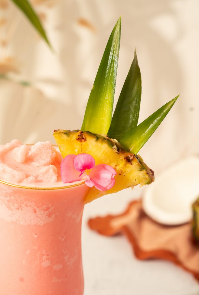 close up of pineapple garnish on a pink Aperol Piña Colada