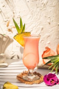 pink Aperol Piña Colada in a hurricane cocktail glass